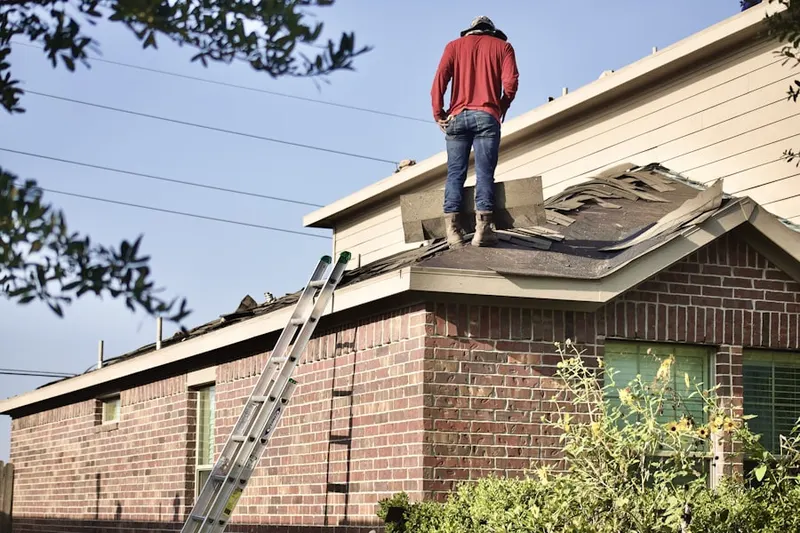 Professional roofer working on a residential roof in Rockleigh